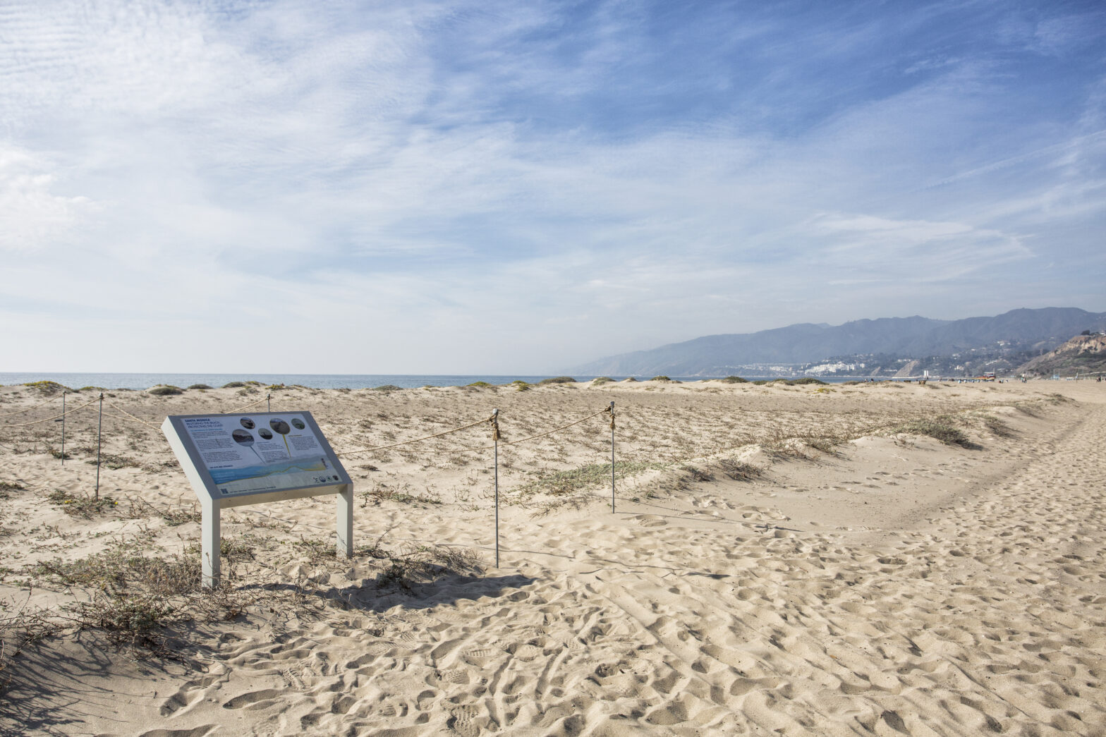 Sandy beach and dunes with bluffs in the background